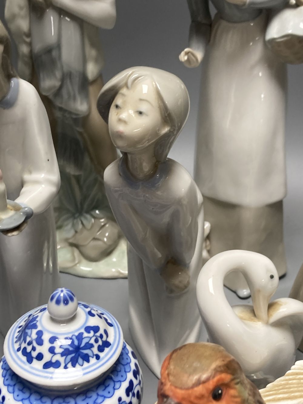 A collection of Lladro and Goebel porcelain figures and other items